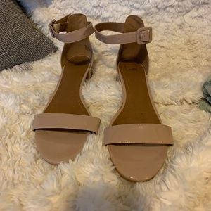 Shiny nude block heels with less than 1” heel height.